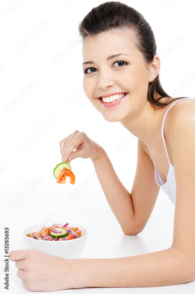 young laughing woman eating healthy salad - isolated on white young laughing woman eating healthy salad - isolated on white