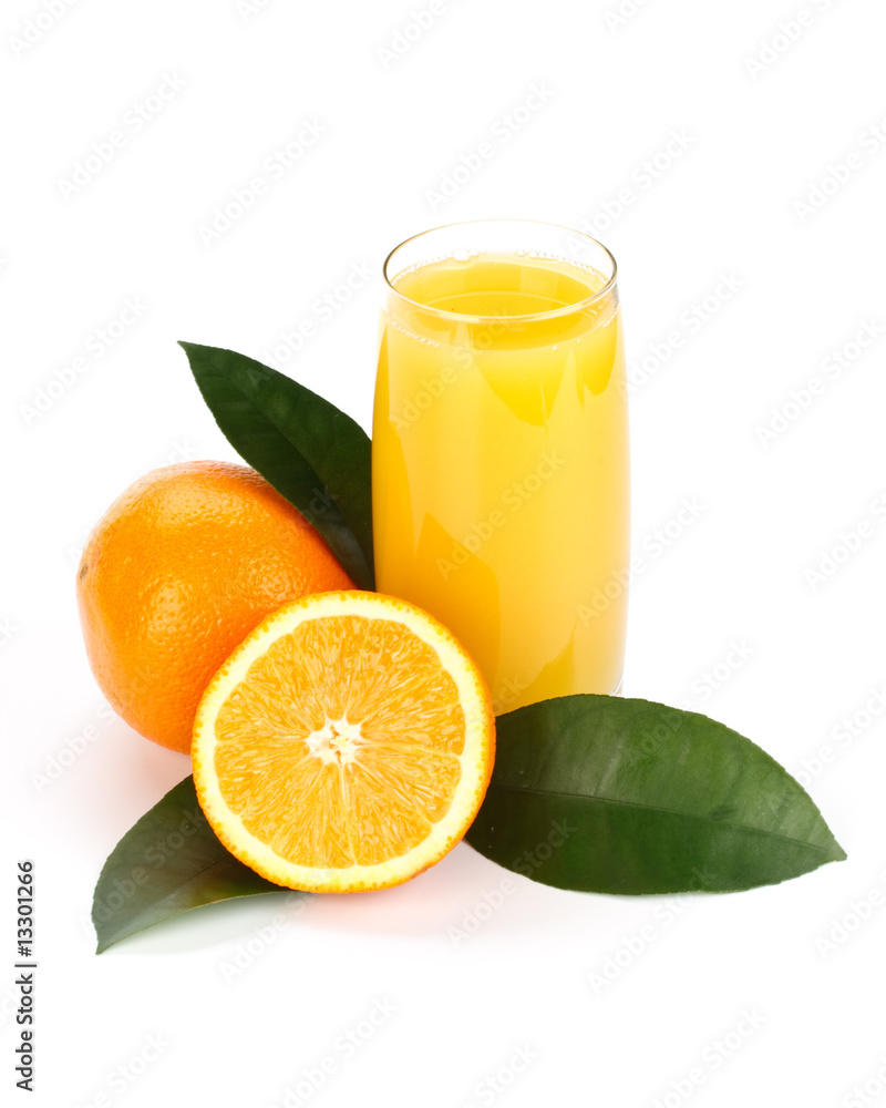 Fruits with green leaves and glass of juice Fruits with green leaves and glass of juice