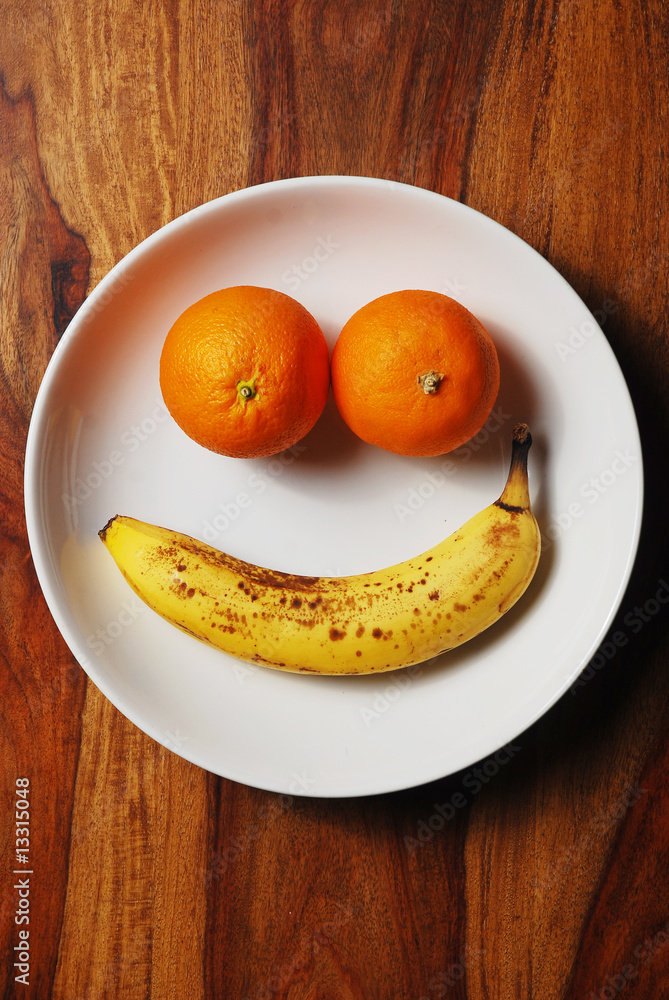 Fruit arranged as happy face on a white plate