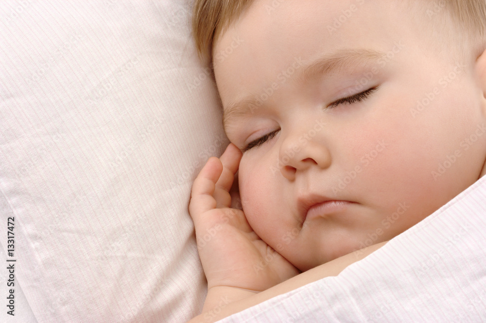 Child sleeping with hand under his cheek Child sleeping with hand under his cheek