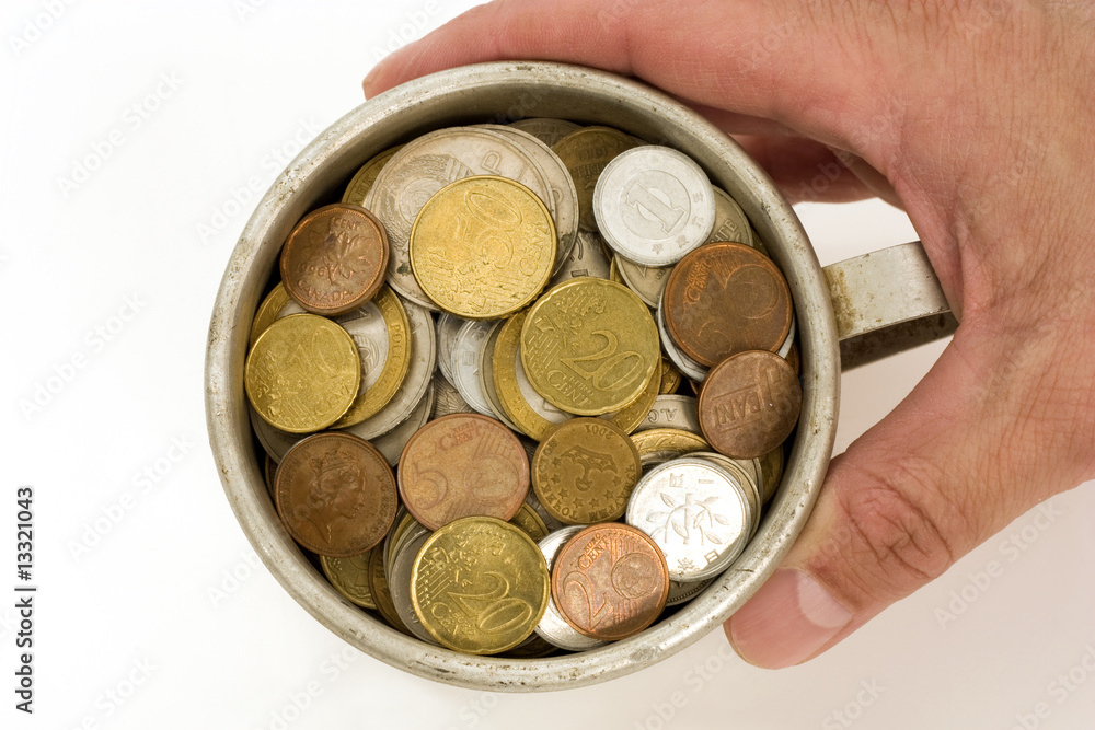 Fototapeta premium The Male hand keeps get old aluminum mug with money.