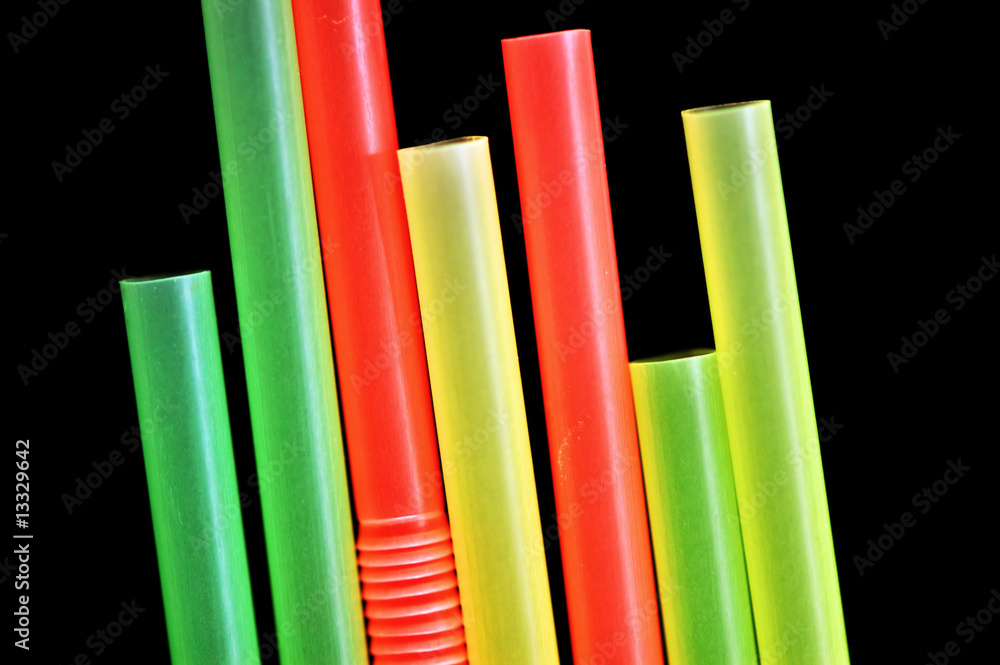 Fototapeta premium Colorful drinking straws against a black background.