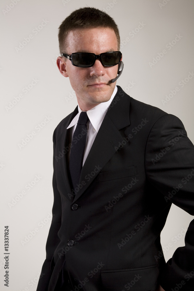 Young man suggesting a secret service agent or secret policeman Young man suggesting a secret service agent or secret policeman