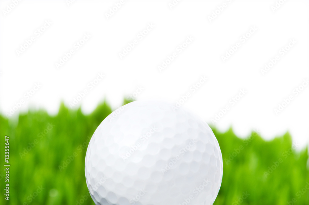 Golf ball and grass isolated on the white background Golf ball and grass isolated on the white background