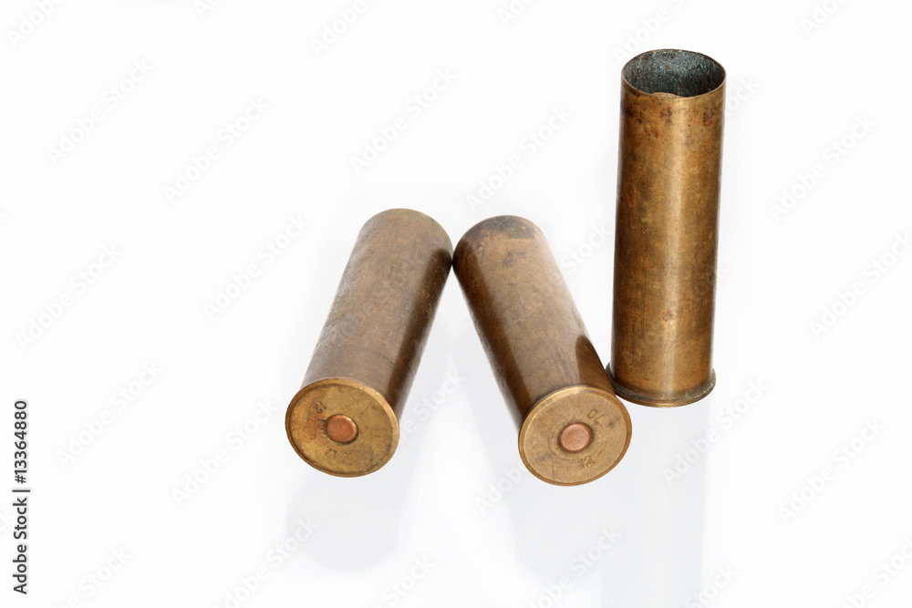 Three old brass cartridges for fowling piece isolated on white Three old brass cartridges for fowling piece isolated on white