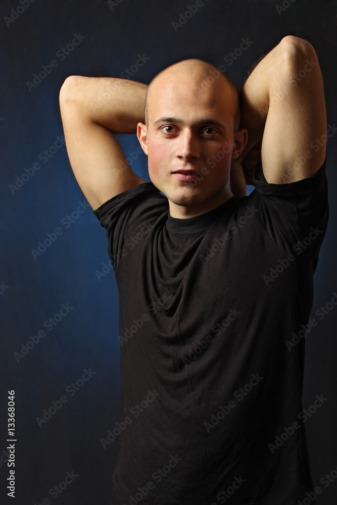 beautiful man in t-shirt on black background