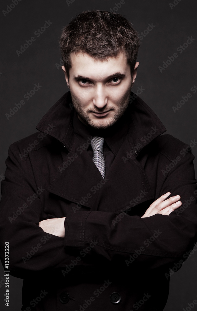 portrait of stern man in black coat