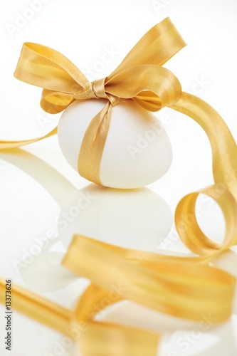 Easter egg with a bow golden
