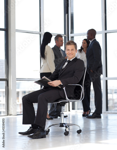 Young attractive businessman in office working