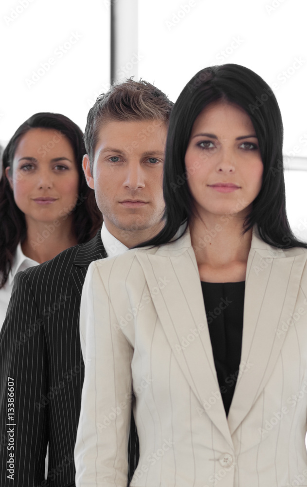 Beautiful young businesspeople in a row looking at the camera Beautiful young businesspeople in a row looking at the camera