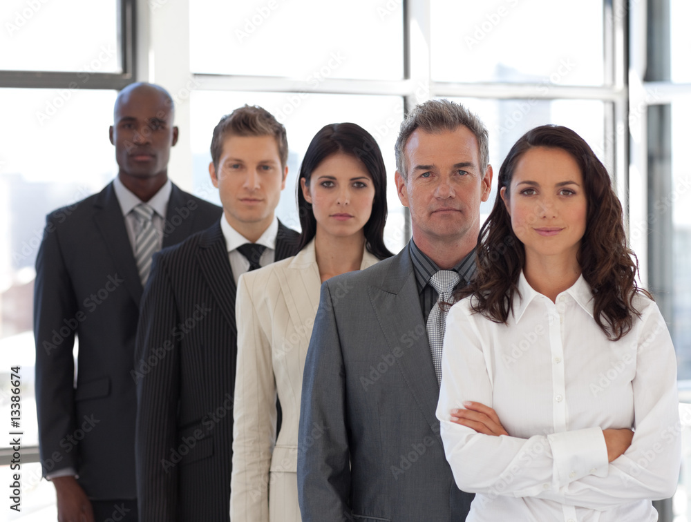 Business woman leading a business team looking at camera Business woman leading a business team looking at camera