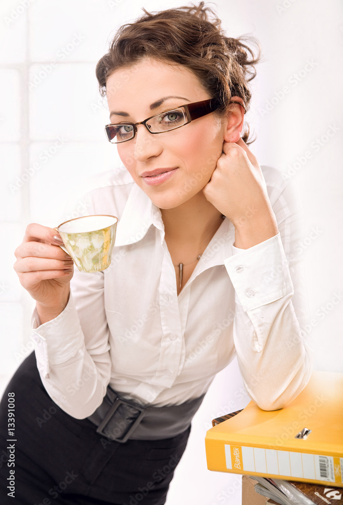 The attractive secretary is drinking coffee The attractive secretary is drinking coffee