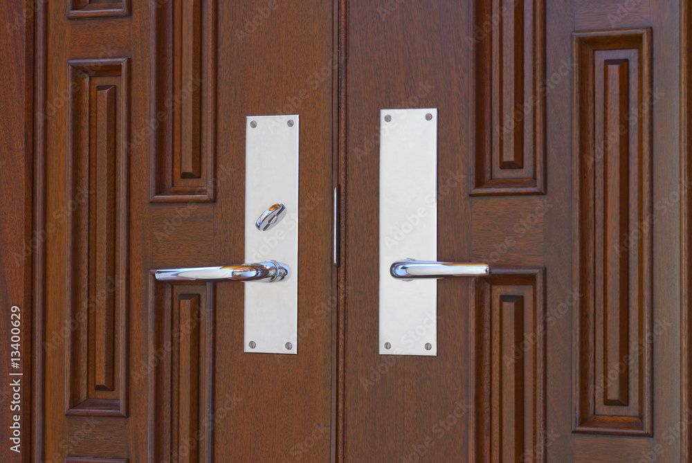 Double door handles on mahogany Double door handles on mahogany