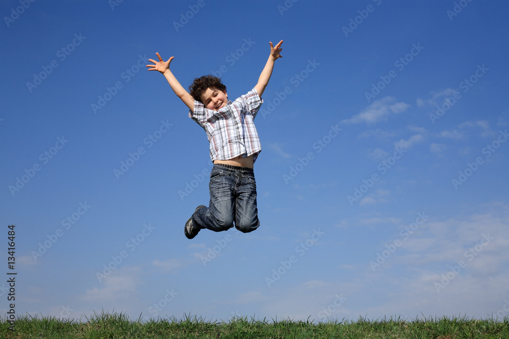 Boy jumping, running against blue sky Boy jumping, running against blue sky
