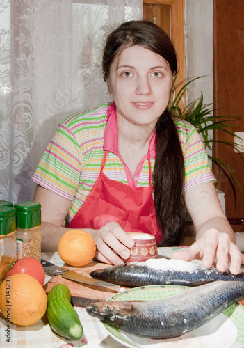 girl is salting a herring photo