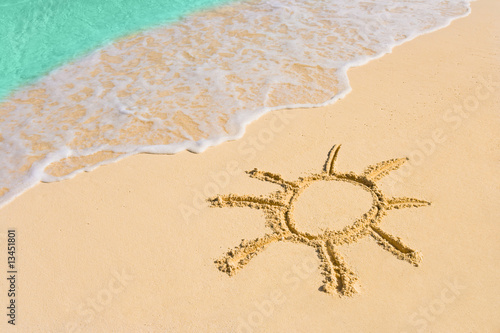 Drawing sun on beach photo