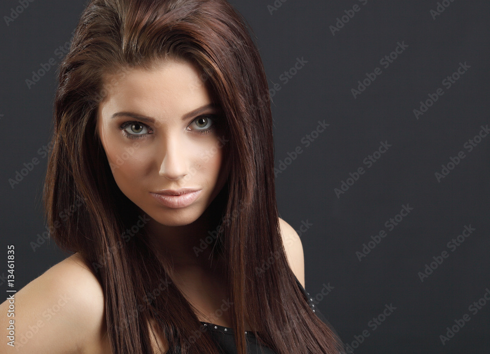 Close-up studio portrait of a sexy young smiling woman. Close-up studio portrait of a sexy young smiling woman.