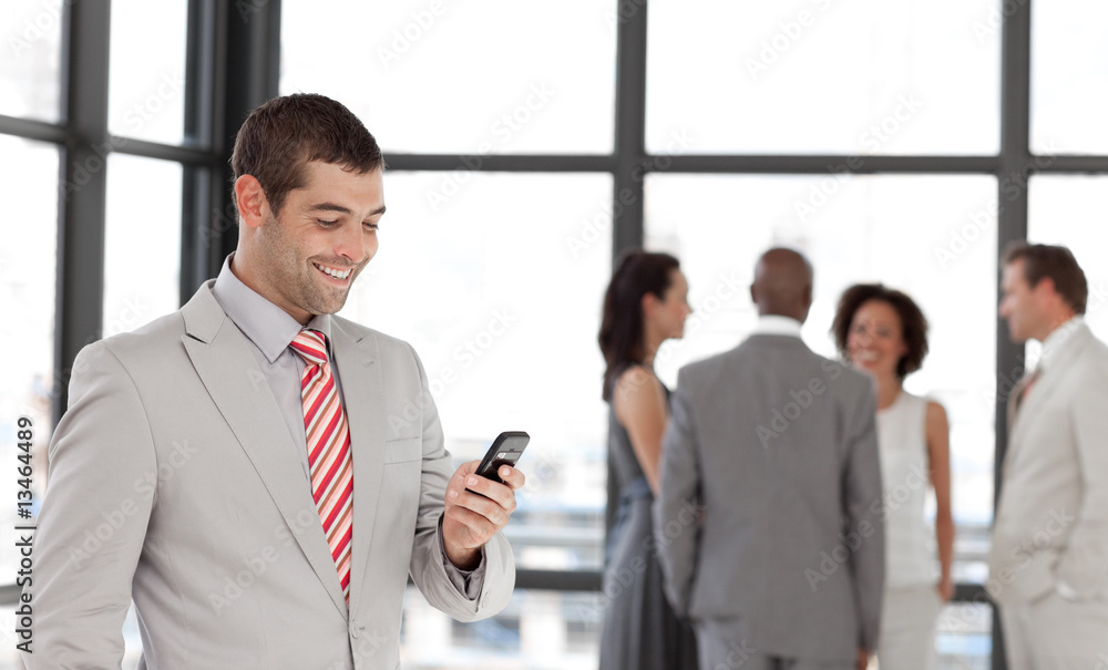 Smiling Businessman sending a text message Smiling Businessman sending a text message