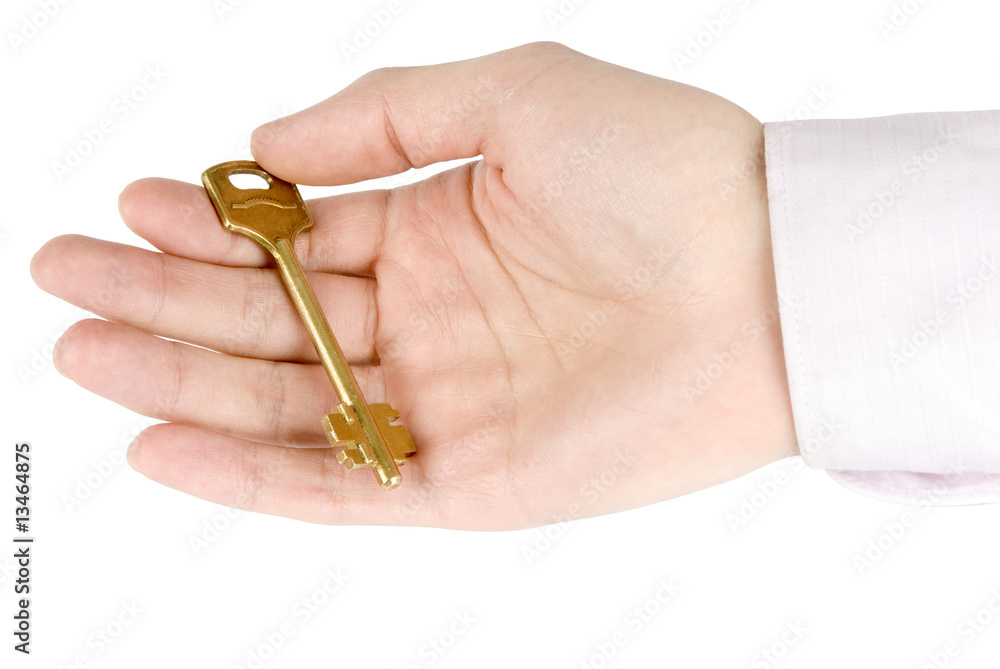 Golden key in the hand isolated on white