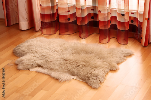 Sheepskin carpet on wooden floor
