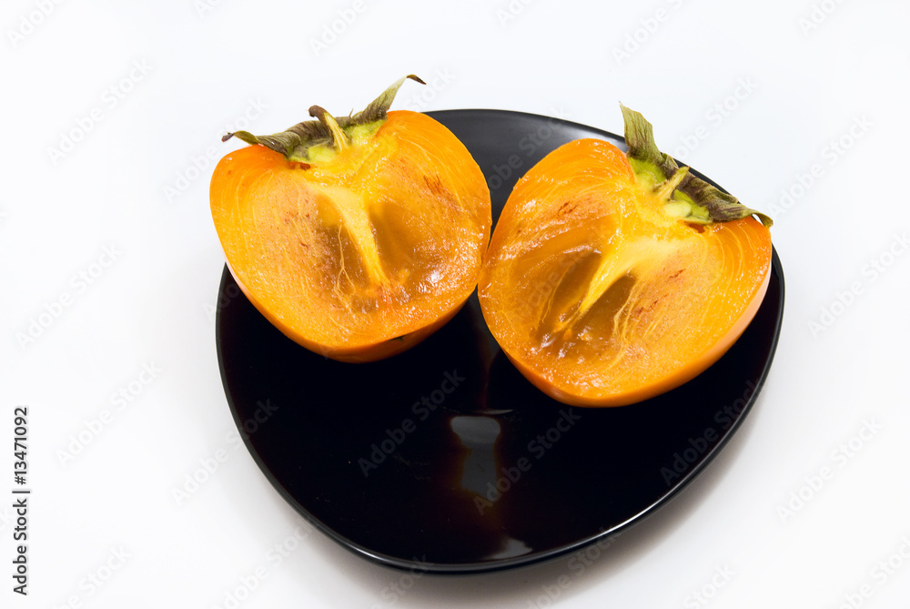 persimmon on a plate on a white background persimmon on a plate on a white background