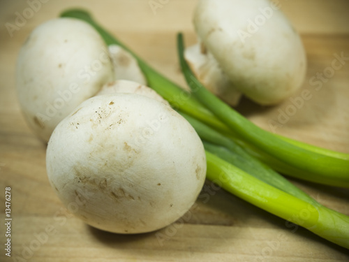 mushroom and onion on a wooden cutting board