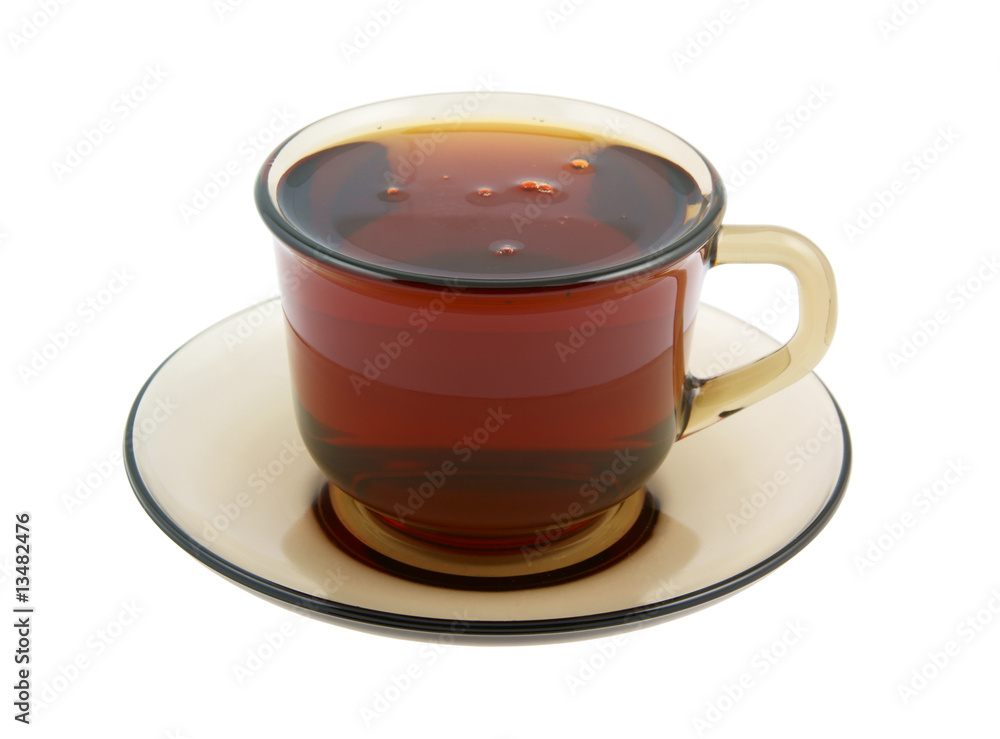 Glass cup of hot tea on plate isolated Glass cup of hot tea on plate isolated