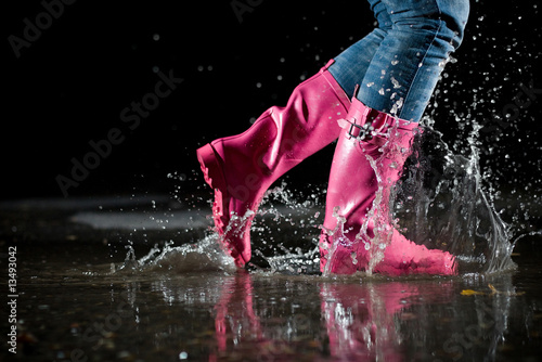 girl jumping in the puddle