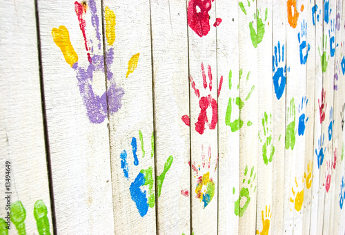 Colorful handprints on wall from an angle