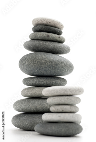 image of balancing stones over white - vertical picture