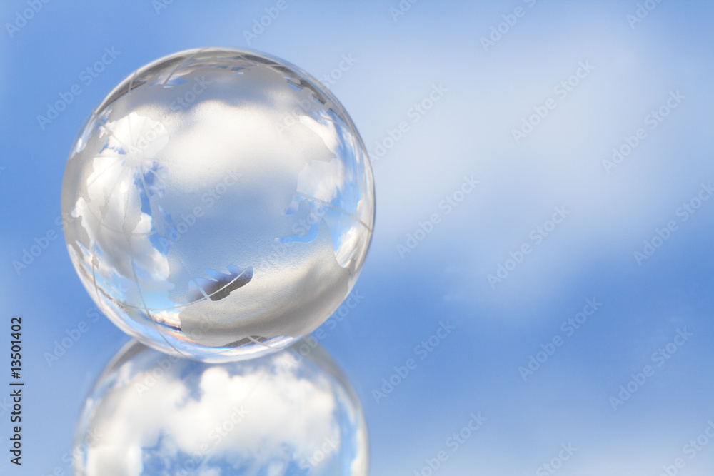 Glassy globe on background with blue sky Glassy globe on background with blue sky