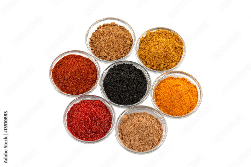 several indian spices in glass bowls several indian spices in glass bowls