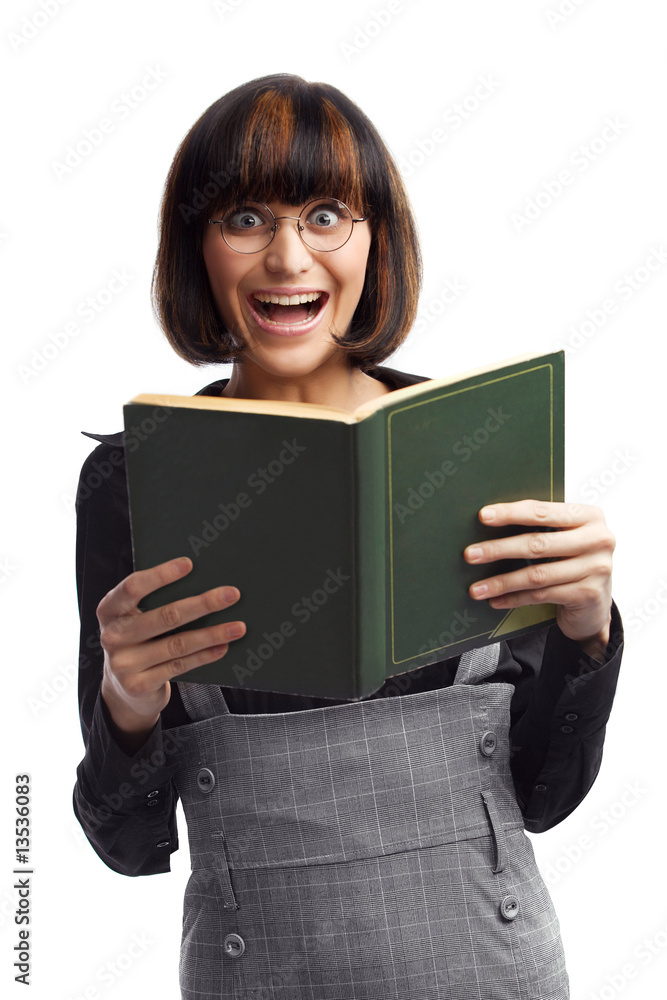 Laughing brunette schoolgirl looking front hold book