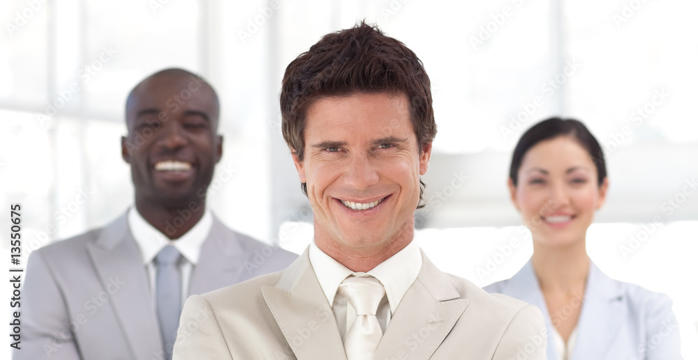 Business man smiling in front of Business team Business man smiling in front of Business team