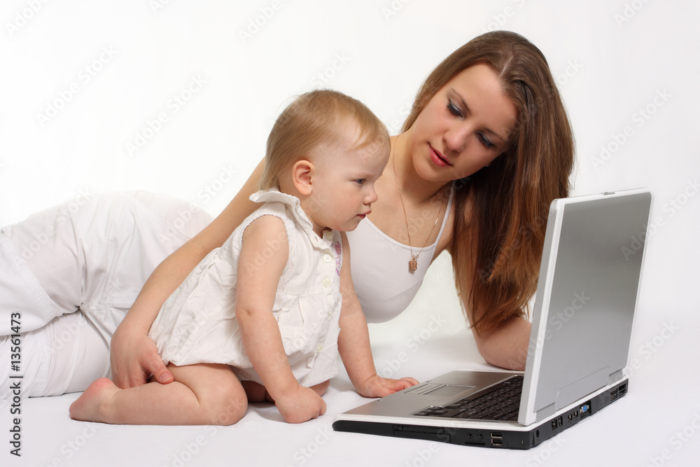 beautiful mother with daughter looking on the laptop beautiful mother with daughter looking on the laptop