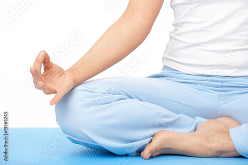 Close-up of the woman's hand doing yoga exercise on mat