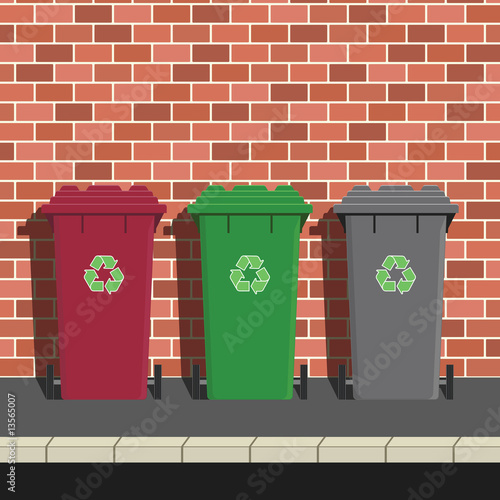 Recycling Bins Against Brick Wall