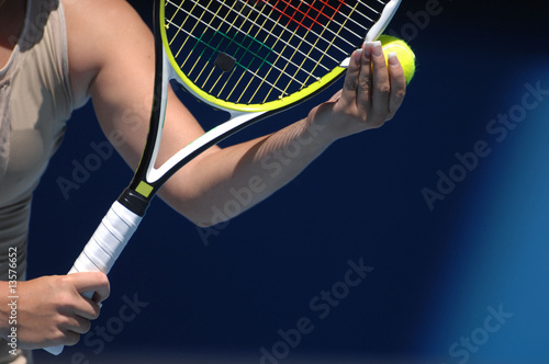 A woman with beautiful hands is holding a tennis ball