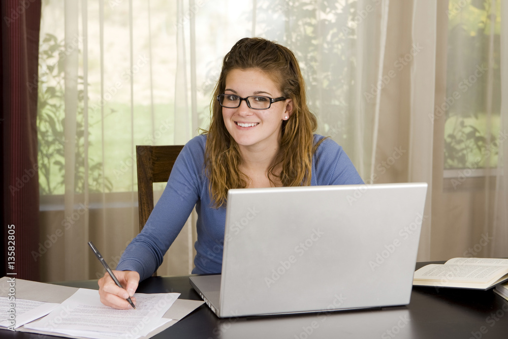 Pretty young girl using her laptop at home Pretty young girl using her laptop at home
