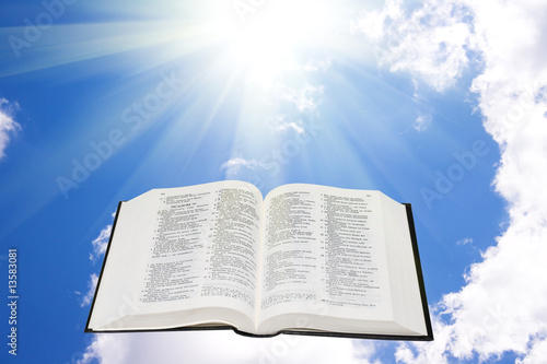 Holy bible in the sky illuminated by a sunlight