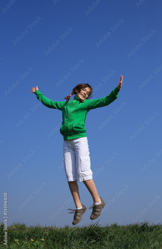 Girl jumping, running against blue sky Girl jumping, running against blue sky