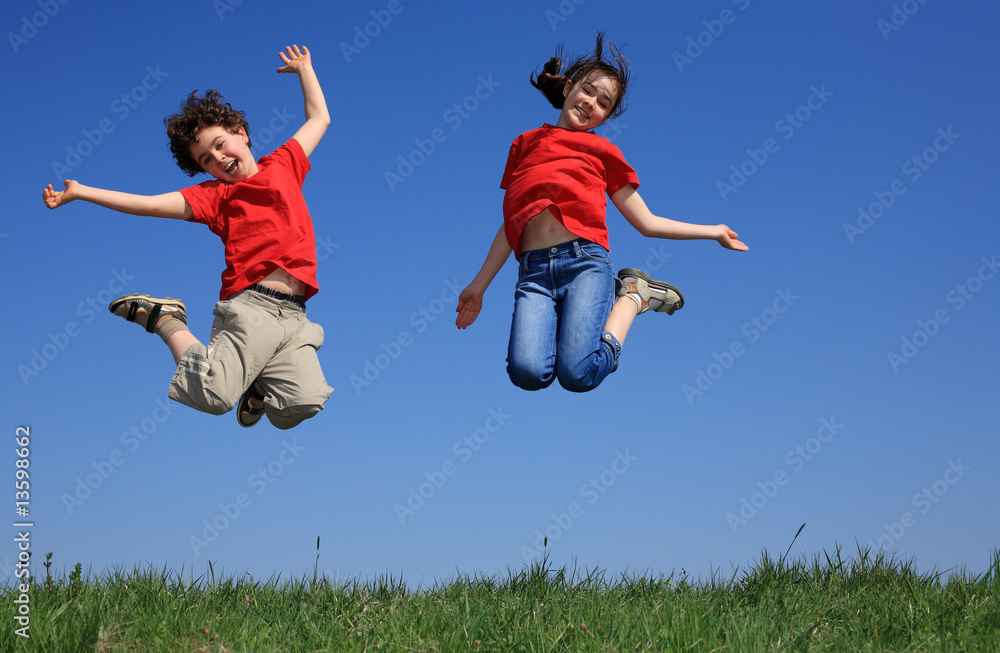 Kids jumping, running against blue sky Kids jumping, running against blue sky