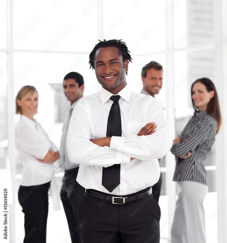 Portrait of a businessman standing in front of co-workers Portrait of a businessman standing in front of co-workers