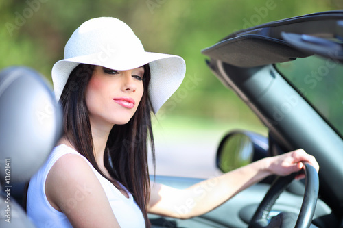 portrait of beautiful summer woman in the car