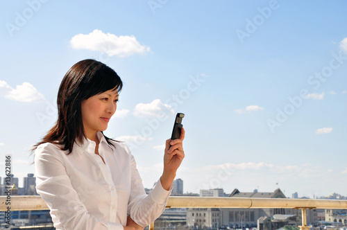 businesswoman with mobile phone, outside
