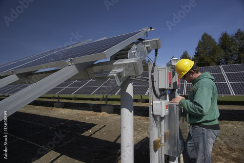 Solar panels inspected by workman