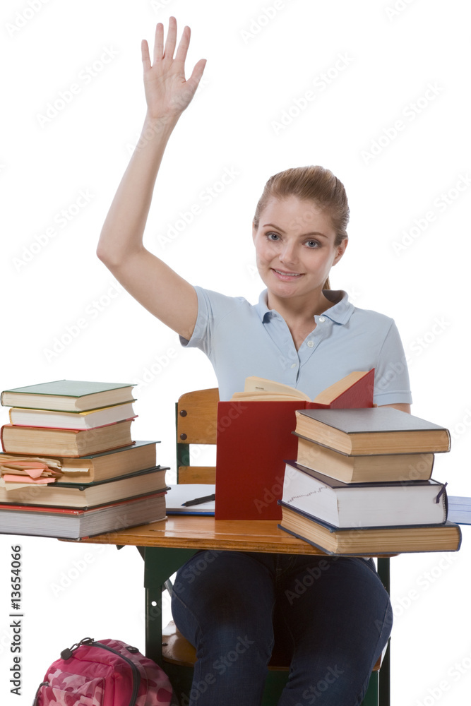 Caucasian schoolgirl with raised hand in class Caucasian schoolgirl with raised hand in class