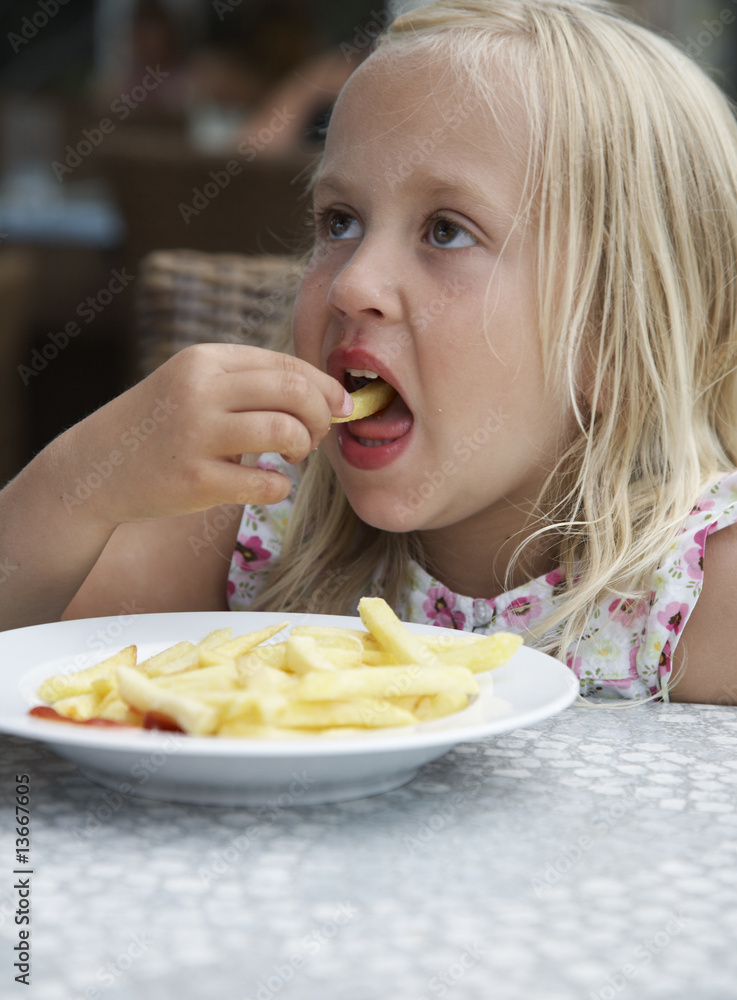Girl eats fried potatoes Girl eats fried potatoes