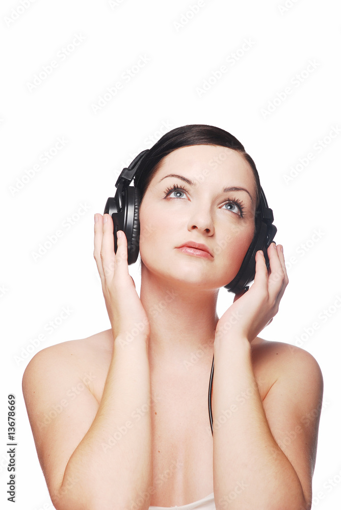 Beautiful brunette woman wearing headphones looking up Beautiful brunette woman wearing headphones looking up