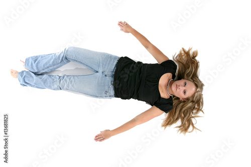 фотографія young woman on her back on the floor with arms out